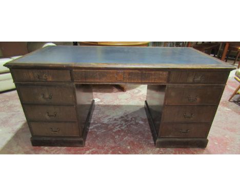 A Georgian style mahogany ladies writing desk fitted with nine graduated drawers and two cupboards, with inset green leather 