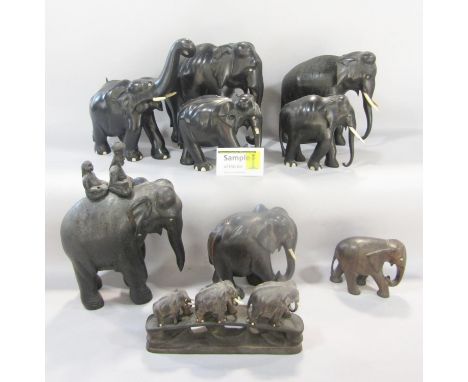 A large red travelling trunk with a large collection of ebony elephants and elephant groups, af 
