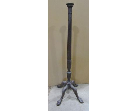 19th century mahogany torchere with turned and fluted column raised on a carved quadruped base, with lions paw feet, later ad