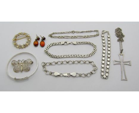 Group of silver jewellery comprising four chain bracelets of various design, a christening bangle, filigree butterfly brooch,