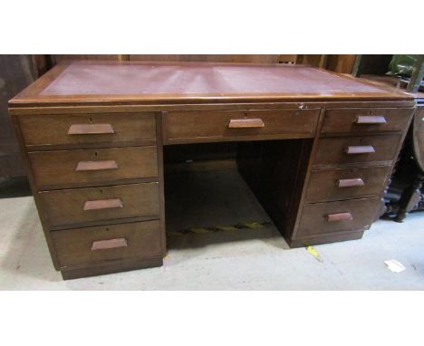 An art deco period writing desk, with nine drawers beneath an inset top, 153cm x 90cm 