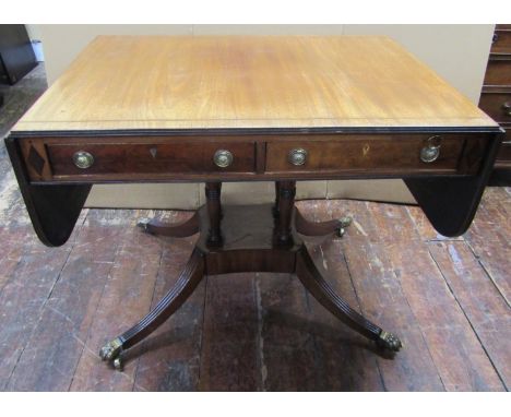 A regency mahogany sofa/centre table enclosing two frieze drawers, (which can be opened from either side) raised on four turn