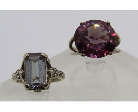 Two synthetic sapphire dress rings; a gold example, size T, 7.7g and a silver example, size R 