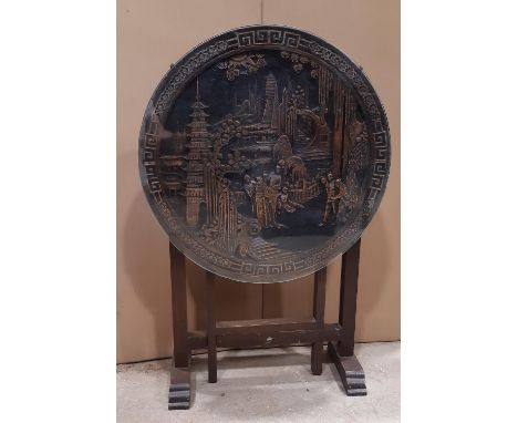 A carved Chinese hardwood circular tilt top occasional table with gate leg action 61cm in diameter 