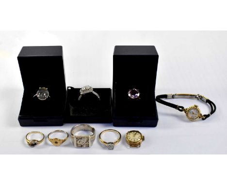 Four silver dress rings including a gentlemen's example, an example set with amethyst stone and one set with white stones, al