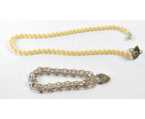 A silver gate-style bracelet with hallmarked silver heart-shaped padlock catch, together with a silver ring set with marcasit