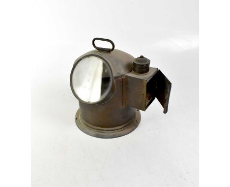 CHADBURNS LTD OF LIVERPOOL; a ship's compass in a brass case with side compartment for a small paraffin lamp, height 26cm.