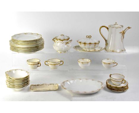 A Havilland &amp; Co Limoges part tea set in cream with gilt scalloped edges, comprising teapot, lidded sugar bowl, tea cups,