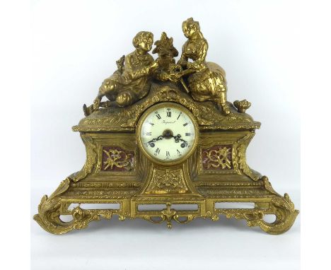 A modern Italian Imperial gilt metal mantel clock with romantic couple scene to the top, barrel movement, the dial set with e