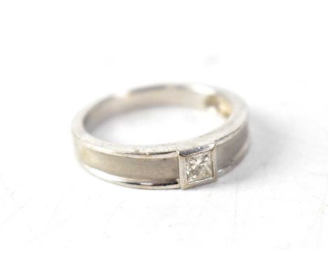 A white metal dress ring set with small diamond, size K.