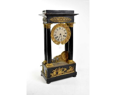 A Victorian ebonised and gilt metal mounted mantel clock, the dial set with Roman numerals and enclosing an eight day movemen