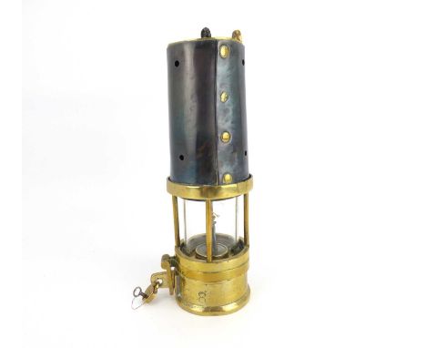 A vintage brass and steel bound miner's lamp with number '3749' on an oval brass plaque, with lock and padlock, height 23cm.H