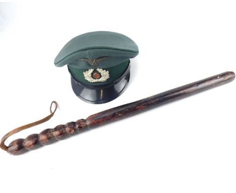 A 19th century long Police truncheon with bobbin turned handle, length 57cm, with leather strap, also a  German military cap 