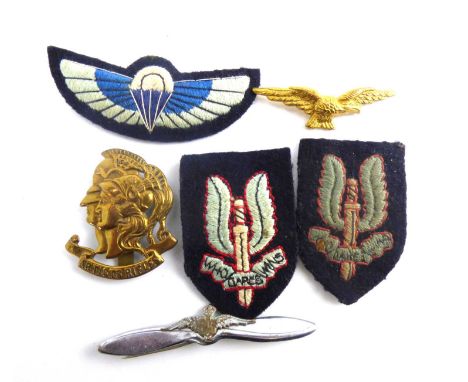 A padded embroidered SAS Qualification Jump wings, two embroidered winged dagger cloth badges including an early example, RAF