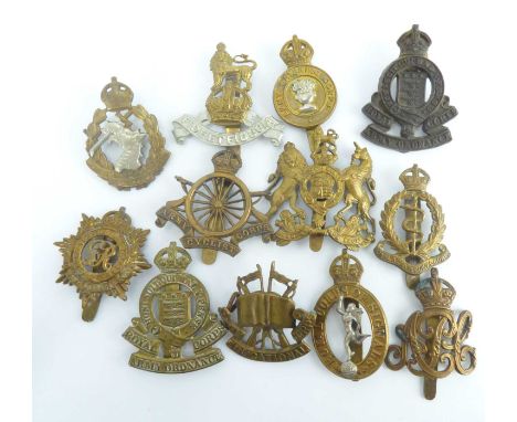 Twelve military services cap badges to include Royal Corps of Signals, Royal Army Medical Corps, Royal Army Service, Army Pay