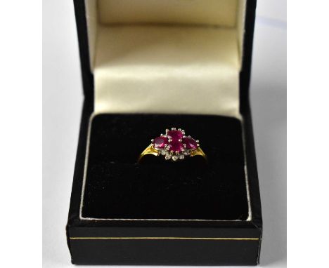 An 18ct yellow gold diamond and ruby cluster ring of marquise form, size J, approx. 4.15g.