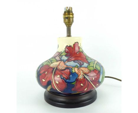 MOORCROFT; a table lamp of squat baluster form decorated with hibiscus-style pattern on an ivory ground, height to top of fit