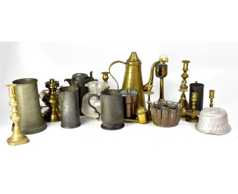 A group of late 19th/early 20th century mixed metalware to include pewter tankards and measuring jug, brass candlesticks and 