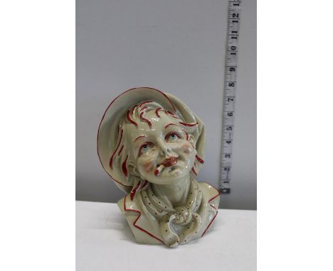 A heavy ceramic bust figure of a young boy 