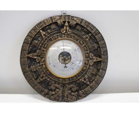A vintage wall hanging barometer 