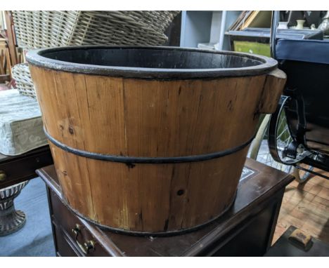 A Victorian pine wash tub/planter having twin handles and wrought iron support, 35cm h x 62.5cm wLocation: 