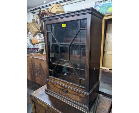 A George III mahogany cabinet on cabinet, the upper part with a glazed door, over a drawer, on bracket feet, 73cm high 38cm w