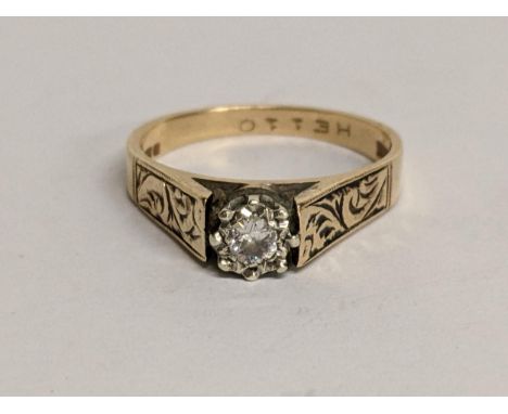 A 9ct gold diamond ring in a claw setting and engraved shoulders, 3.2gLocation: 