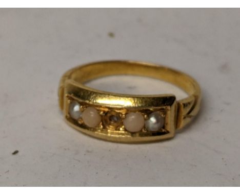 A yellow metal ring inset with seed peals, central stone missing. 3.8gLocation: 