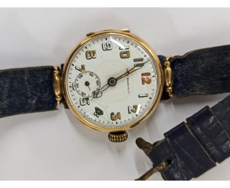 An early 20th century trench watch A/F stamped 14K having a white enamel dial inscribed Alex Ross &amp; Co on a leather strap