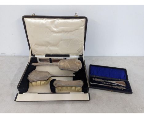 A boxed silver mounted dressing table brushes and comb, along with a cased set of silver handled shoe horn setLocation: 