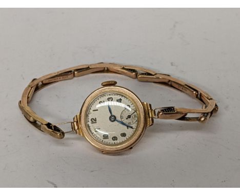 An early 20th century 9ct gold ladies manual wind wristwatch on a 9ct gold expanding bracelet, 13.1gLocation: 