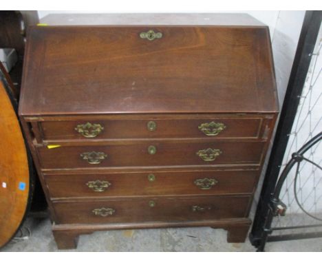 A Georgian mahogany bureau of one short and three long graduated drawers, fall flap revealing a pigeon hole and drawer fitted