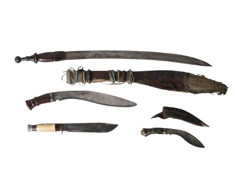 A group of four edged weapons, comprising: a kukri with curved single edged blade, 32cm, with star motif, wood hilt with ridg