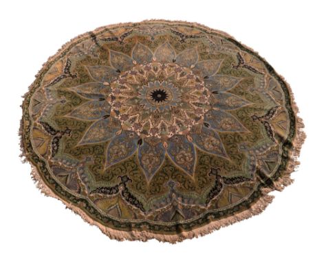 A Tabriz circular carpet, with flower head pole medallion surrounded by barbed edge flower head medallion in blue, on an oliv