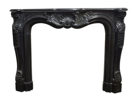 A large Louis XV Rococo style marble fireplace, the black Namur marble carved with ornately shaped frieze, with central shell