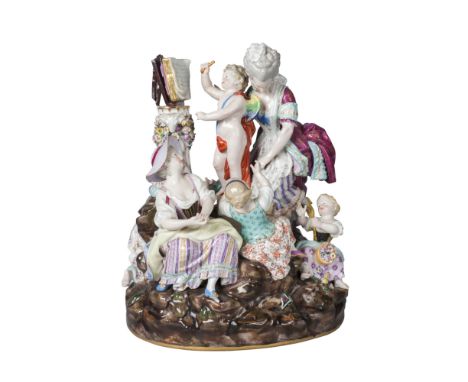 A large Meissen allegorical figure group of Cupid and Venus, late 19th century, with Cupid reading from a book set on a flora