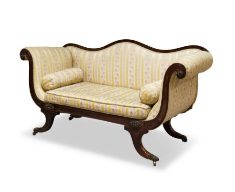 A Victorian upholstered mahogany chaise longue, with serpentine backrest, upholstered in floral fabric, with one loose cushio