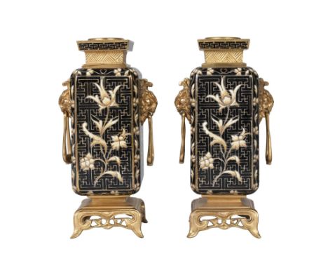 A pair of French gilt bronze and cloisonné vases, in the Chinese taste, 19th century, hung with handles from lions masks, on 