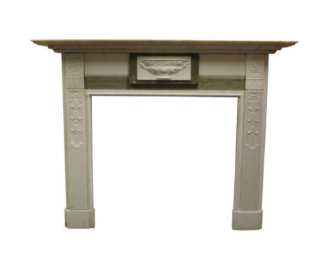 A marble fireplace, early 20th Century, with breakfront shelf, over a central tablet with a vine hung urn, the jambs carved w