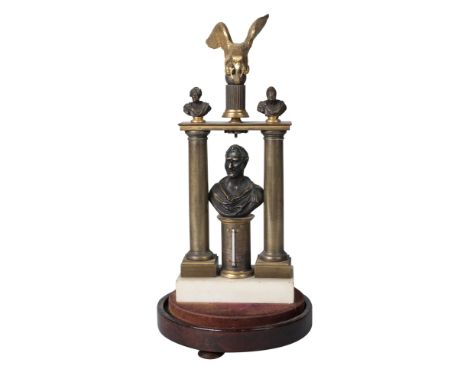 A Regency bronze and marble watch stand, of architectural form, with two columns mounted with an eagle flanked by two busts o