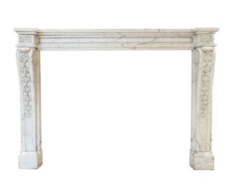 A French Louis XVI cheminee, in carved white veined Carrara marble, simple breakfront shelf over floral paterae endblocks, on