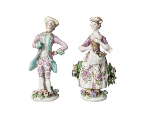 A pair of English porcelain figures of a girl and boy, probably Bow, 18th century, the boy with pink frocked coat with green 