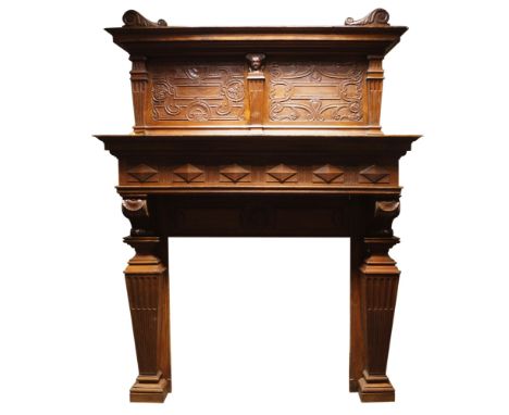 A large French Art Nouveau carved oak chimneypiece, circa. 1900, the panelled frieze set beneath the cornice shelf is support