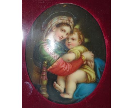 A Continental oval ceramic plaque depicting the Madonna &amp; Child, 8.2 x 6cm, framed. 