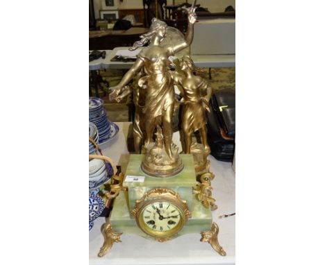 A gilt and green onyx finish three-piece clock garniture surmounted by classical female figures, a gilt and onyx mantel clock
