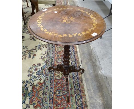 An early-20th century walnut circular-top table, with inlaid leaf and floral decoration, on bobbin-turned column and triform 