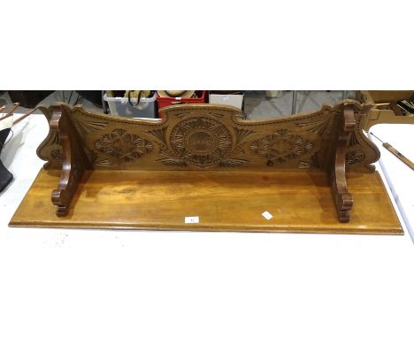 A carved wood hanging wall shelf, 110cm long, 27cm high, (a/f), an oak two-tier table with glass top and caned ends and a can