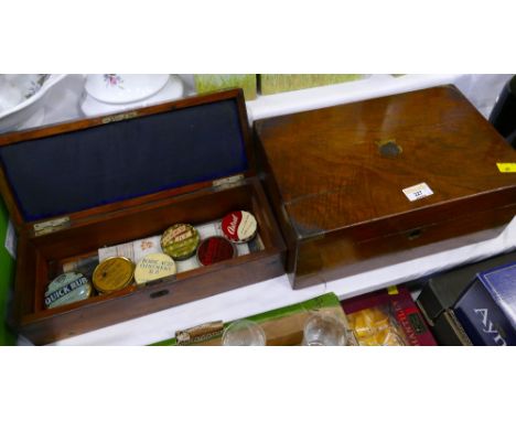 Two wooden boxes with brass edging, one containing vintage ointment tins