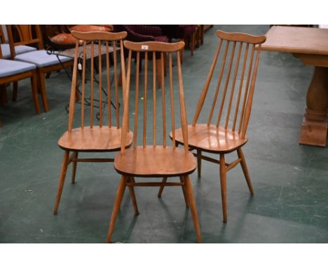 Three spindle back chairs, in the manner of Ercol