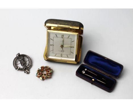 Travel alarm clock, two stick pins and two brooches 